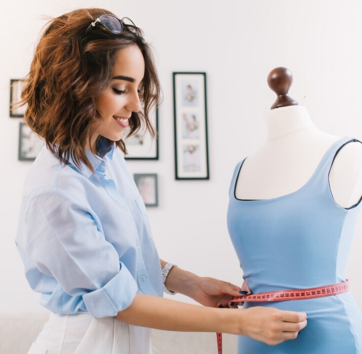 Fashion designer measuring a garment